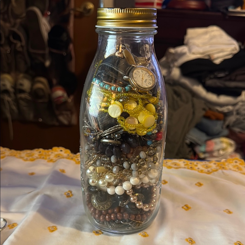Assorted Jewelry in Glass Bottle